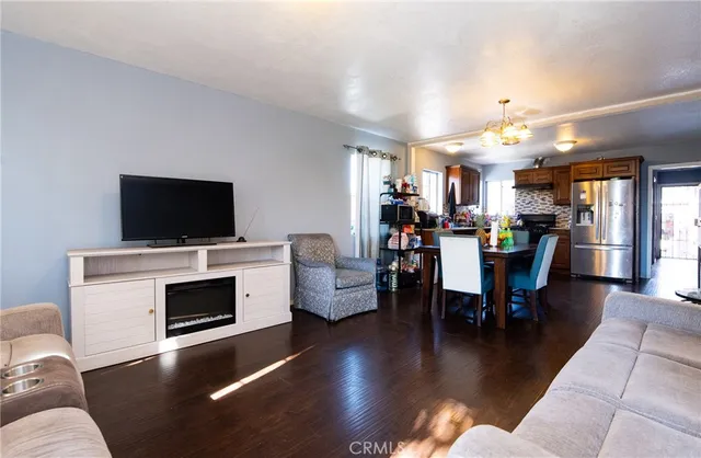 a view of a livingroom with furniture and a flat screen tv