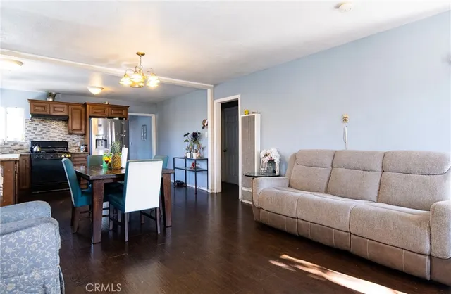 a living room with furniture kitchen view and a dining table