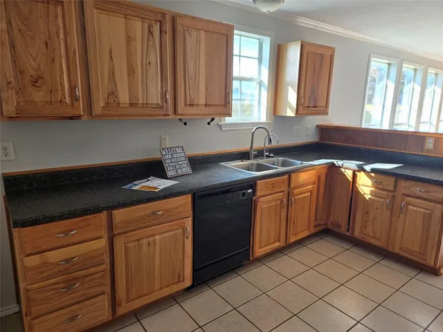 a kitchen with stainless steel appliances granite countertop a sink dishwasher stove and cabinets
