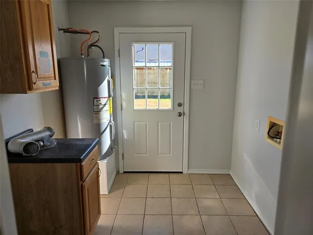 a utility room with window dryer and washer