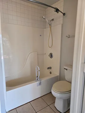 a bathroom with a toilet and shower