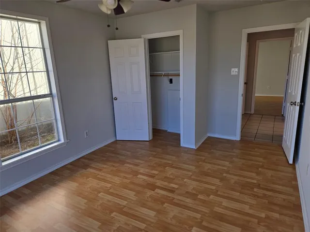 an empty room with windows and closet