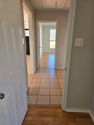 a view of a room with wooden floor and windows