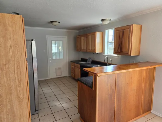 a kitchen with a sink a counter top space and cabinets