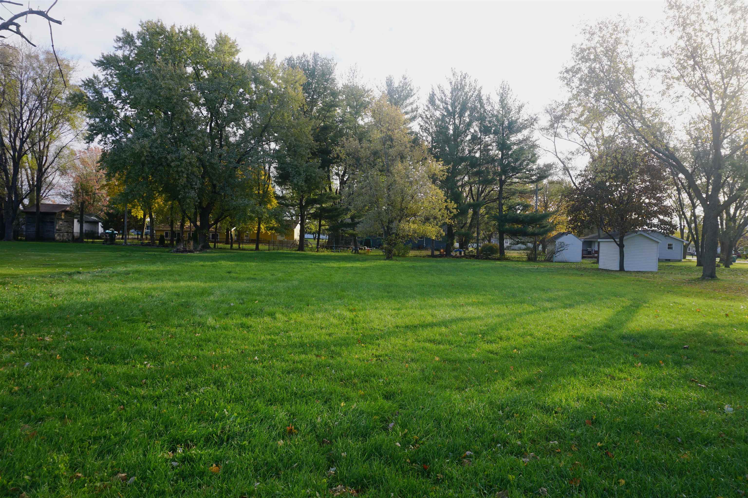 a view of a park with trees around