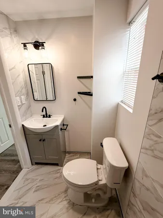 a bathroom with a bathtub sink and mirror