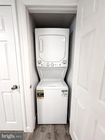 a view of a room with wooden floor and white walls