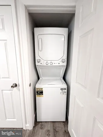 a view of a room with wooden floor and white walls