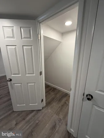a view of kitchen with wooden floor and electronic appliances