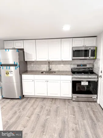 a view of a kitchen with an empty space and a window
