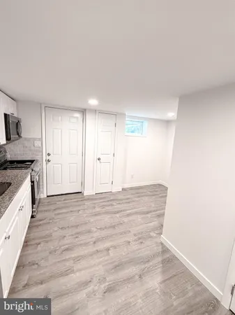 a large white kitchen with a stove a sink and a refrigerator