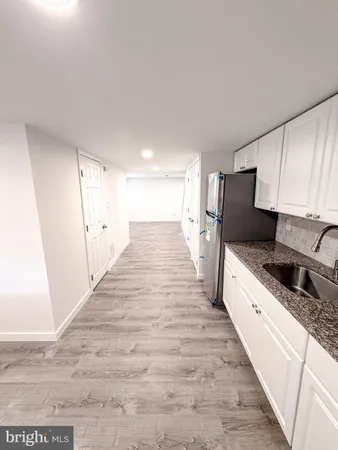 a view of a kitchen cabinets and wooden floor