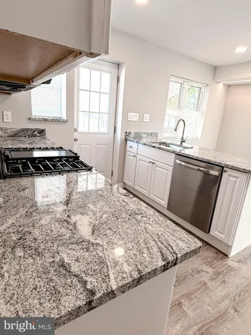 a kitchen with granite countertop a stove and a refrigerator