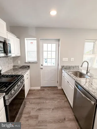 a kitchen with a stove and a microwave