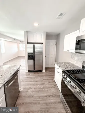 a kitchen with granite countertop a sink and a stove