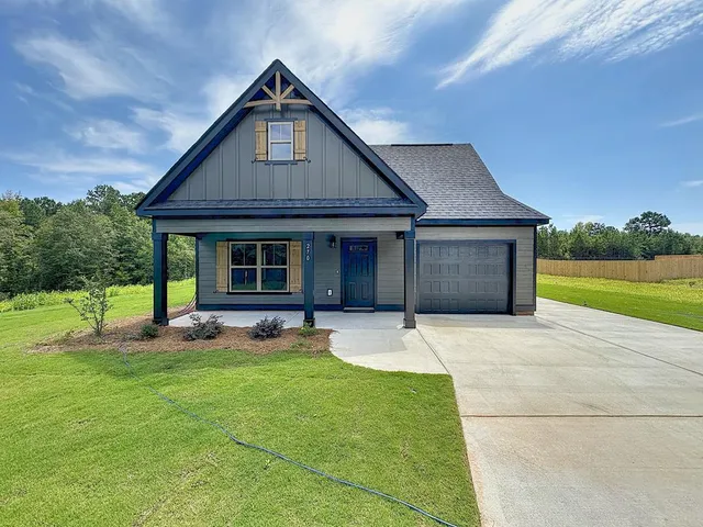 a front view of a house with a yard and porch