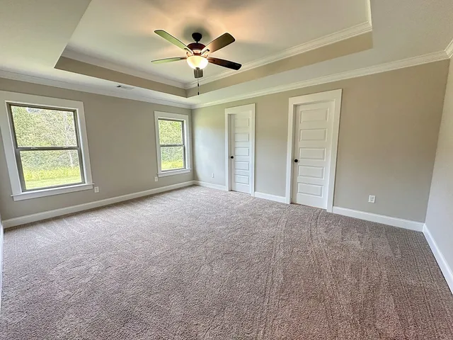 a bathroom with a granite countertop sink a mirror and shower