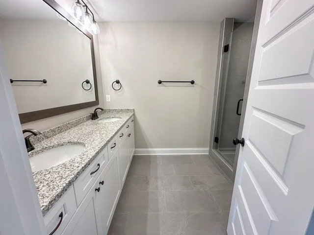 a bathroom with a glass shower door
