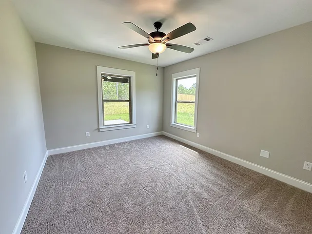 a view of a room with wooden floor and white walls