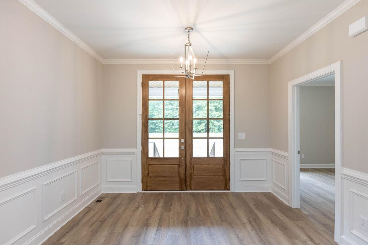 9616 Chris Drive Raleigh, NC 27603 - Photo 13 of 42 wooden floor in an empty room with a window