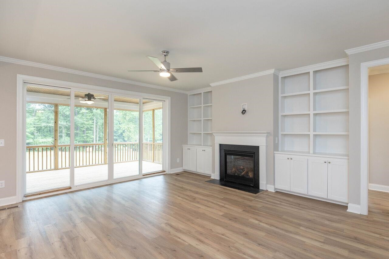 9616 Chris Drive Raleigh, NC 27603 - Photo 16 of 42 a view of an empty room with a fireplace and a window