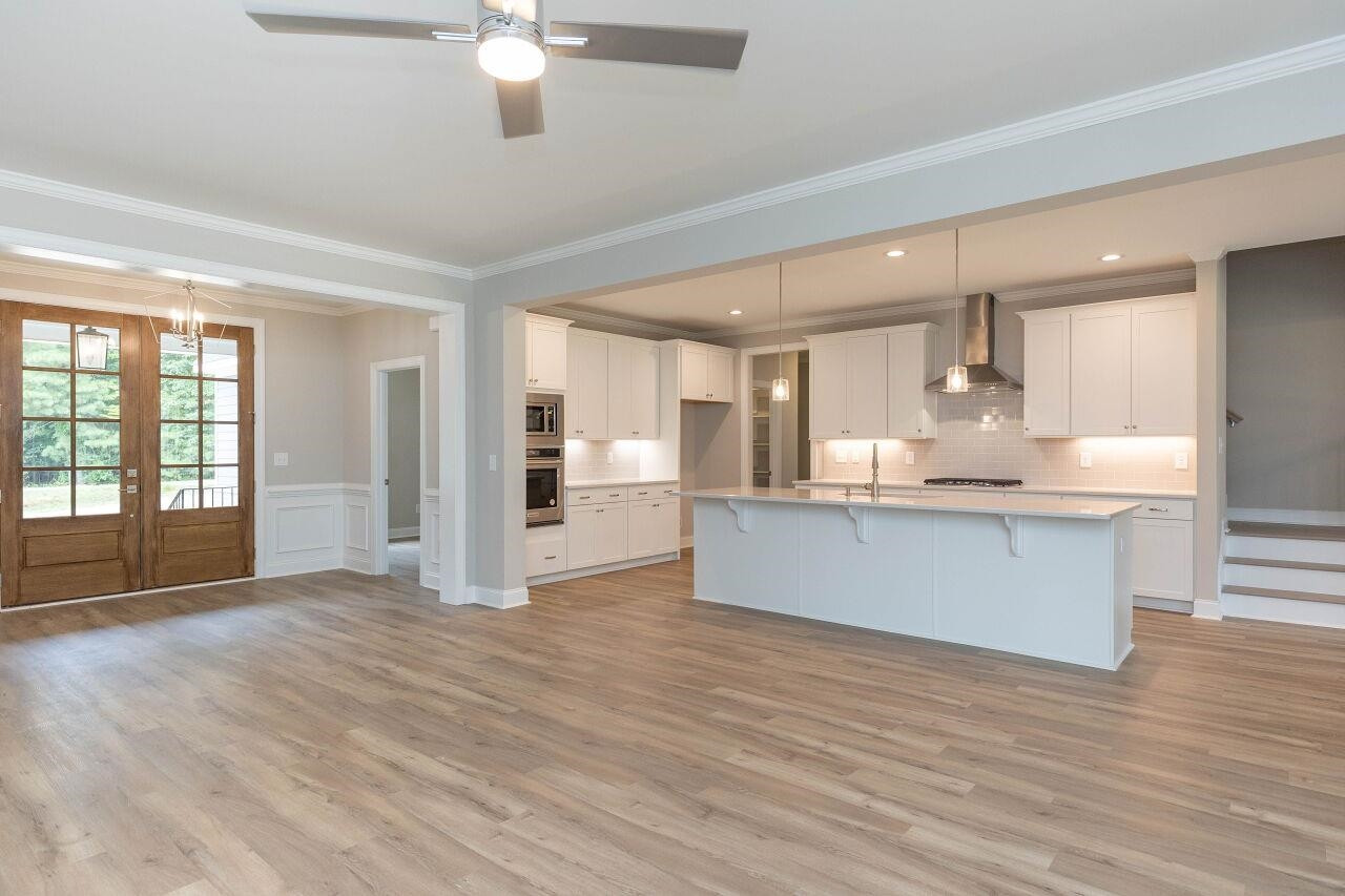 9616 Chris Drive Raleigh, NC 27603 - Photo 19 of 42 a large kitchen with a large counter top and stainless steel appliances