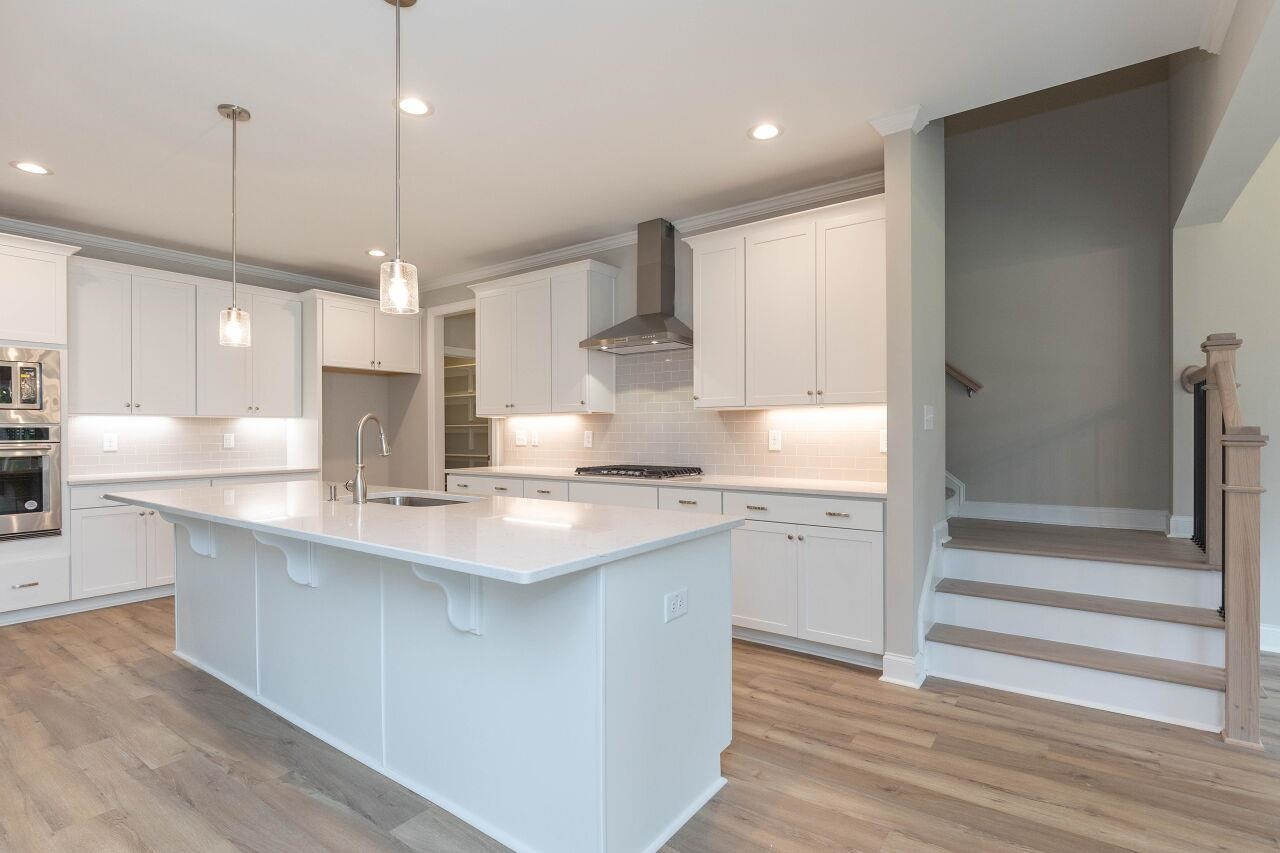 9616 Chris Drive Raleigh, NC 27603 - Photo 20 of 42 a kitchen with stainless steel appliances granite countertop a sink a stove and a refrigerator