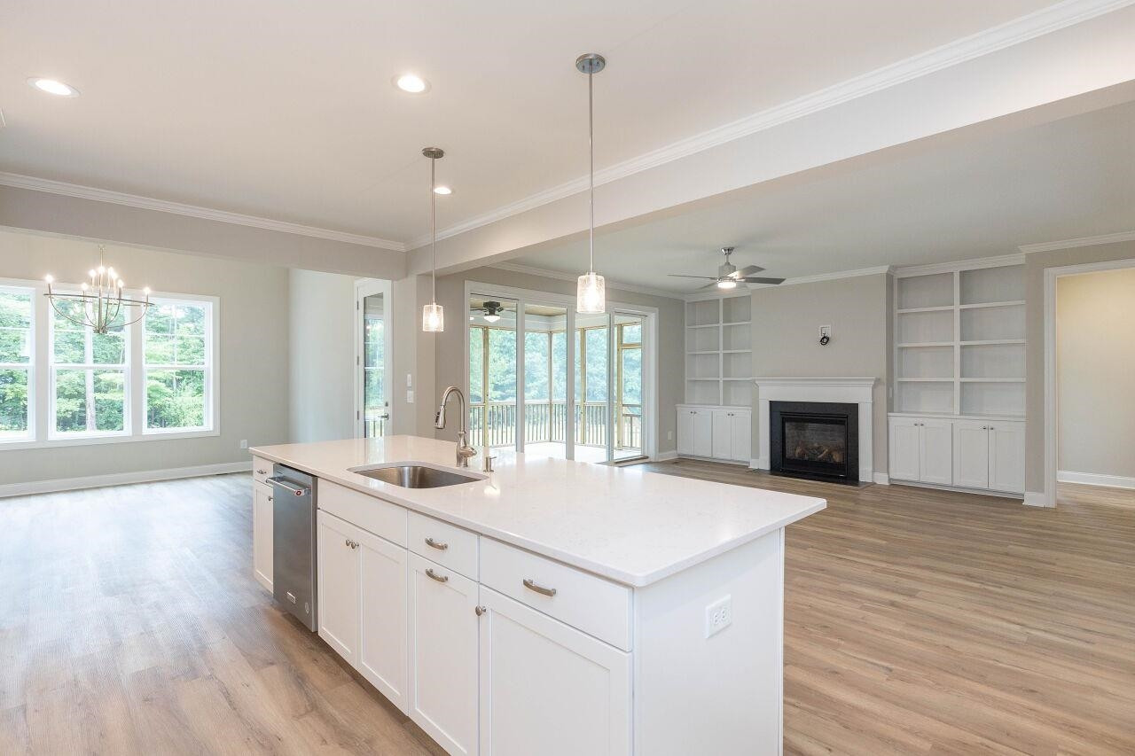 9616 Chris Drive Raleigh, NC 27603 - Photo 23 of 42 a large white kitchen with a large window a oven and a counter space