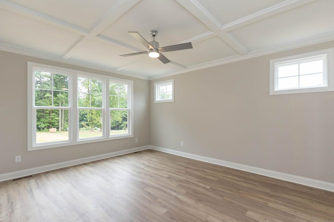 9616 Chris Drive Raleigh, NC 27603 - Photo 25 of 42 a view of an empty room with wooden floor and a window