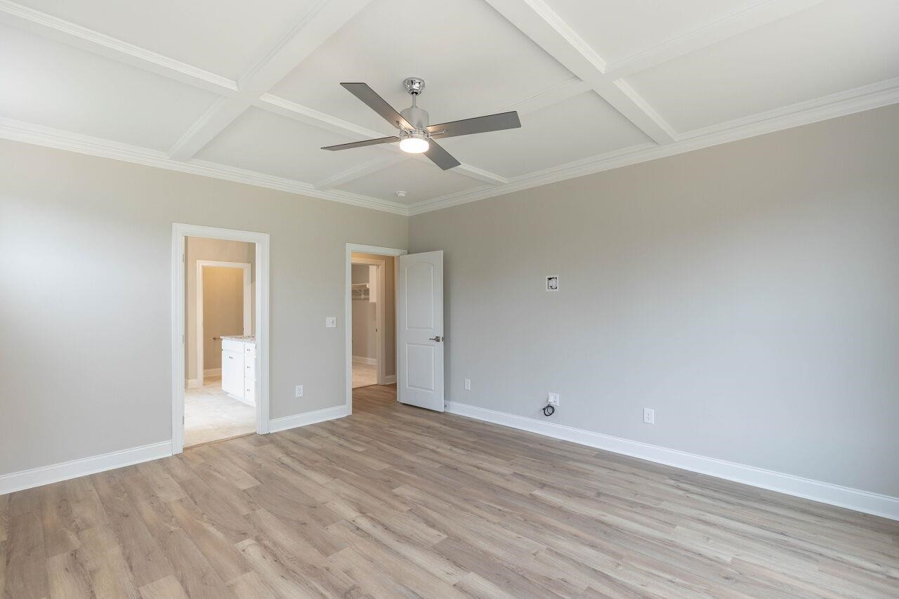 9616 Chris Drive Raleigh, NC 27603 - Photo 26 of 42 a view of an empty room with wooden floor and a ceiling fan