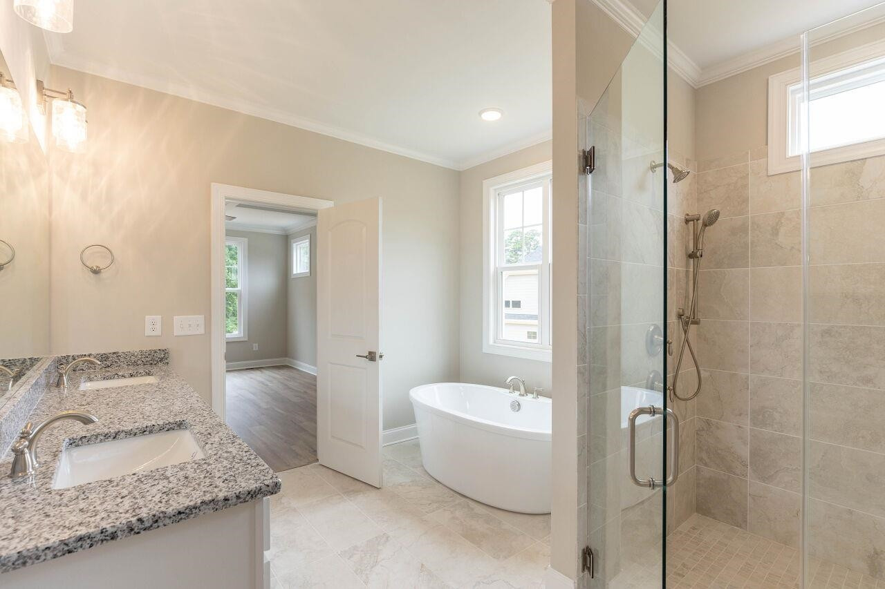 9616 Chris Drive Raleigh, NC 27603 - Photo 29 of 42 a spacious bathroom with a granite countertop sink and a mirror