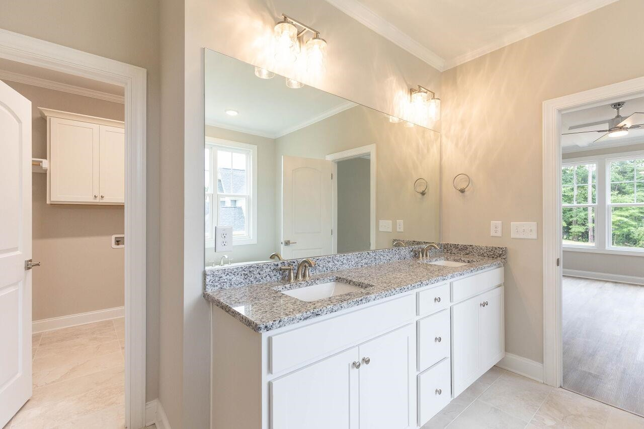 9616 Chris Drive Raleigh, NC 27603 - Photo 30 of 42 a bathroom with a granite countertop sink and a mirror