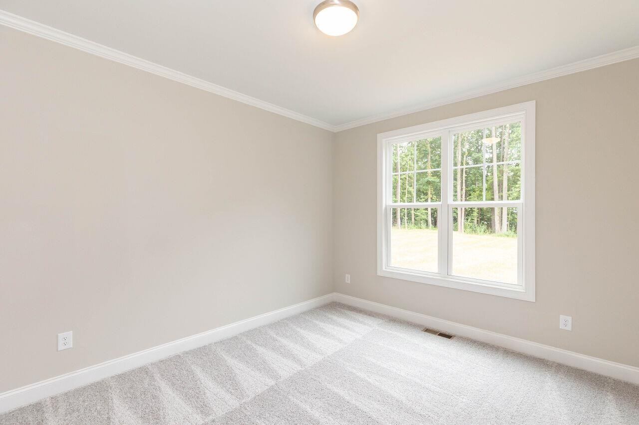 9616 Chris Drive Raleigh, NC 27603 - Photo 32 of 42 an empty room with a window