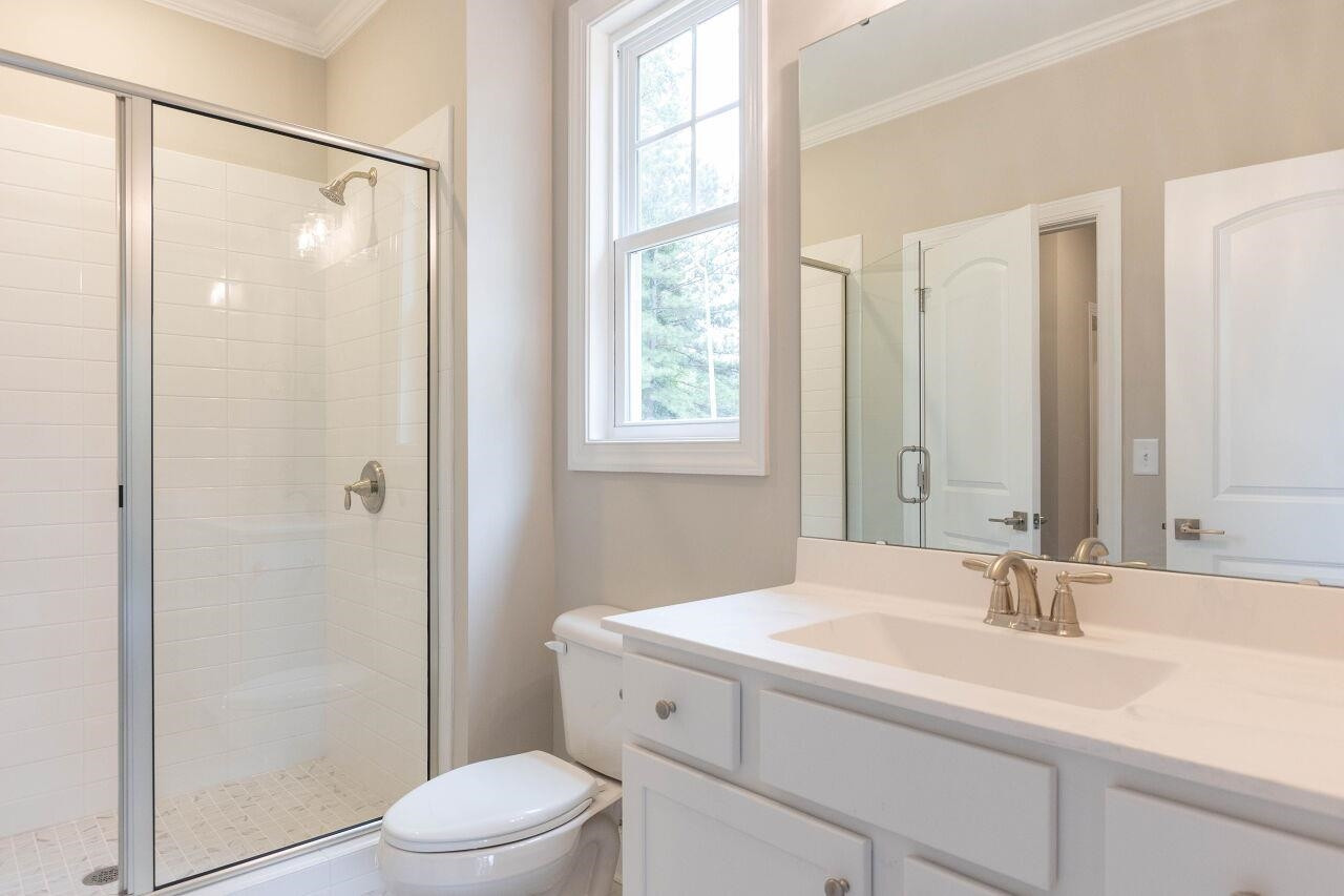 9616 Chris Drive Raleigh, NC 27603 - Photo 34 of 42 a bathroom with a sink toilet vanity and shower