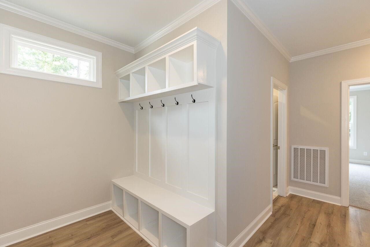 9616 Chris Drive Raleigh, NC 27603 - Photo 35 of 42 an entryway with wooden floor and cabinet