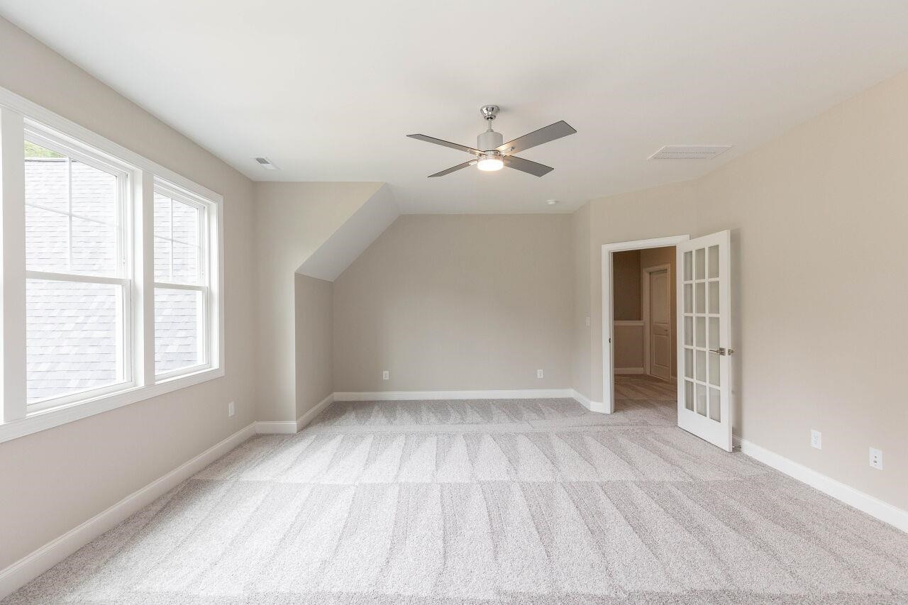 9616 Chris Drive Raleigh, NC 27603 - Photo 6 of 42 a view of empty room with wooden floor and fan