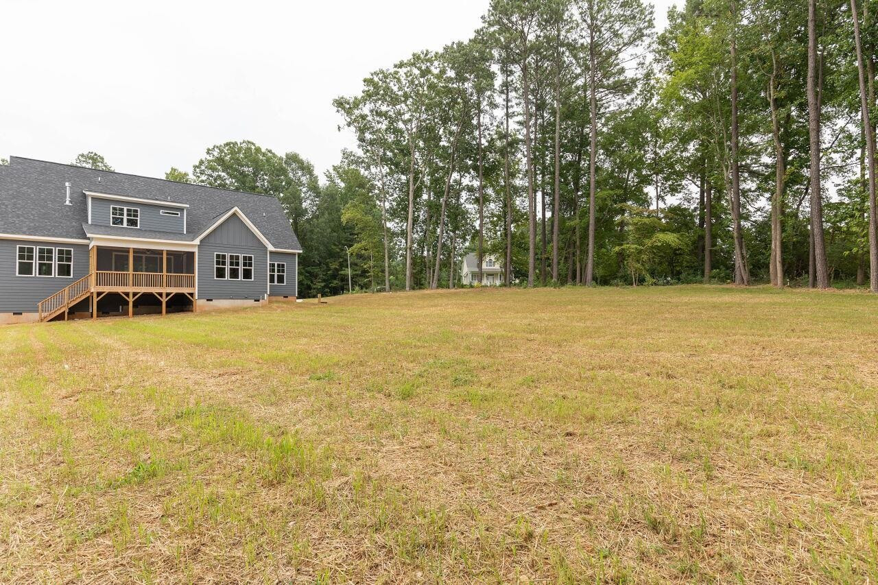 9616 Chris Drive Raleigh, NC 27603 - Photo 10 of 42 a view of an house with backyard and trees
