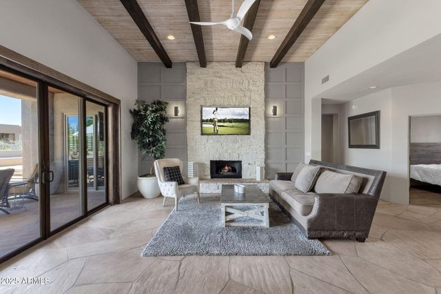 a large kitchen with kitchen island a large counter space appliances and a living room view