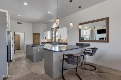 a kitchen with stainless steel appliances granite countertop a stove a refrigerator and a refrigerator