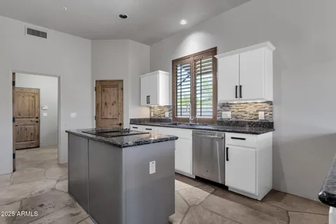 a view of a kitchen with fridge and wooden floor