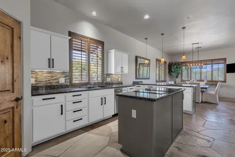 a bedroom with a bed and potted plants with wooden floor