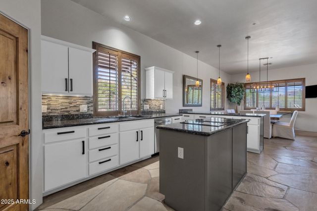 a bedroom with a bed and potted plants with wooden floor