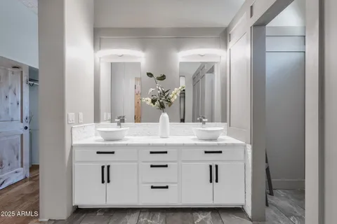 a view of a terrace with couches and wooden fence