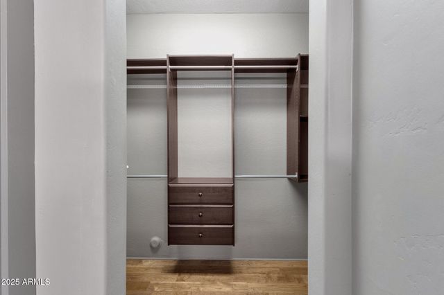 a view of a patio with a table and chairs under an umbrella