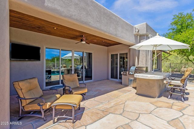 a view of a swimming pool with lounge chairs in patio