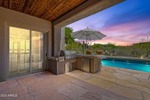 a view of a swimming pool and lounge chairs