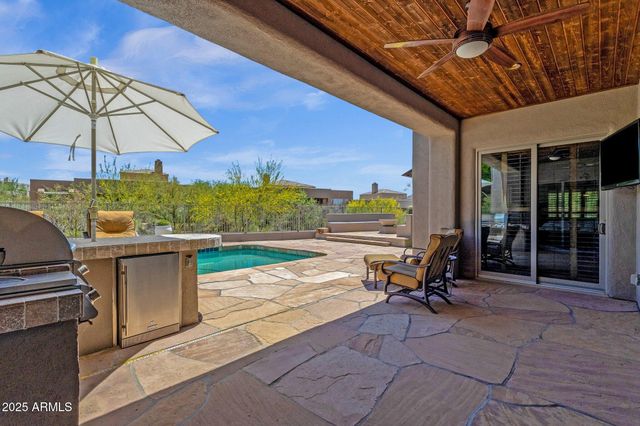 a view of a patio with swimming pool table and chairs