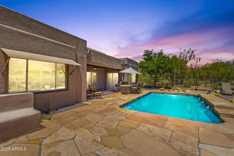 a view of a chair and tables in the patio