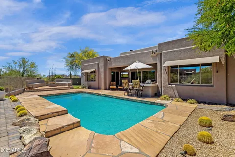 a view of a swimming pool with a yard