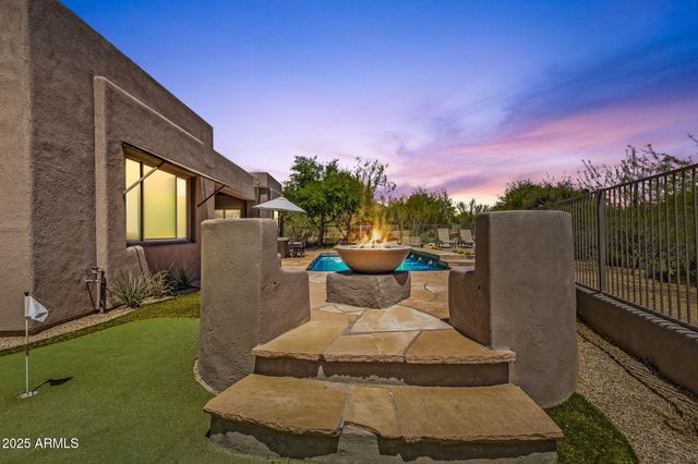 a view of patio with a table and chairs under an umbrella